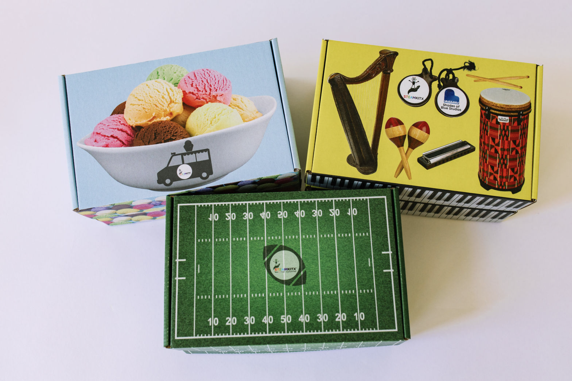 STEAMKITX ice cream, music, and football activity kit boxes
